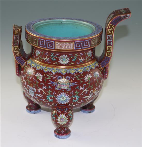 A Chinese famille rose ruby ground tripod censer, Jiaqing six character seal mark and of the period (1796-1820), height 27cm, damage an